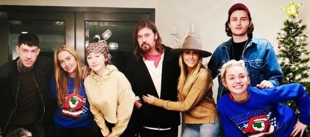 A picture of Tish Cyrus with her husband and five of her six kids.
